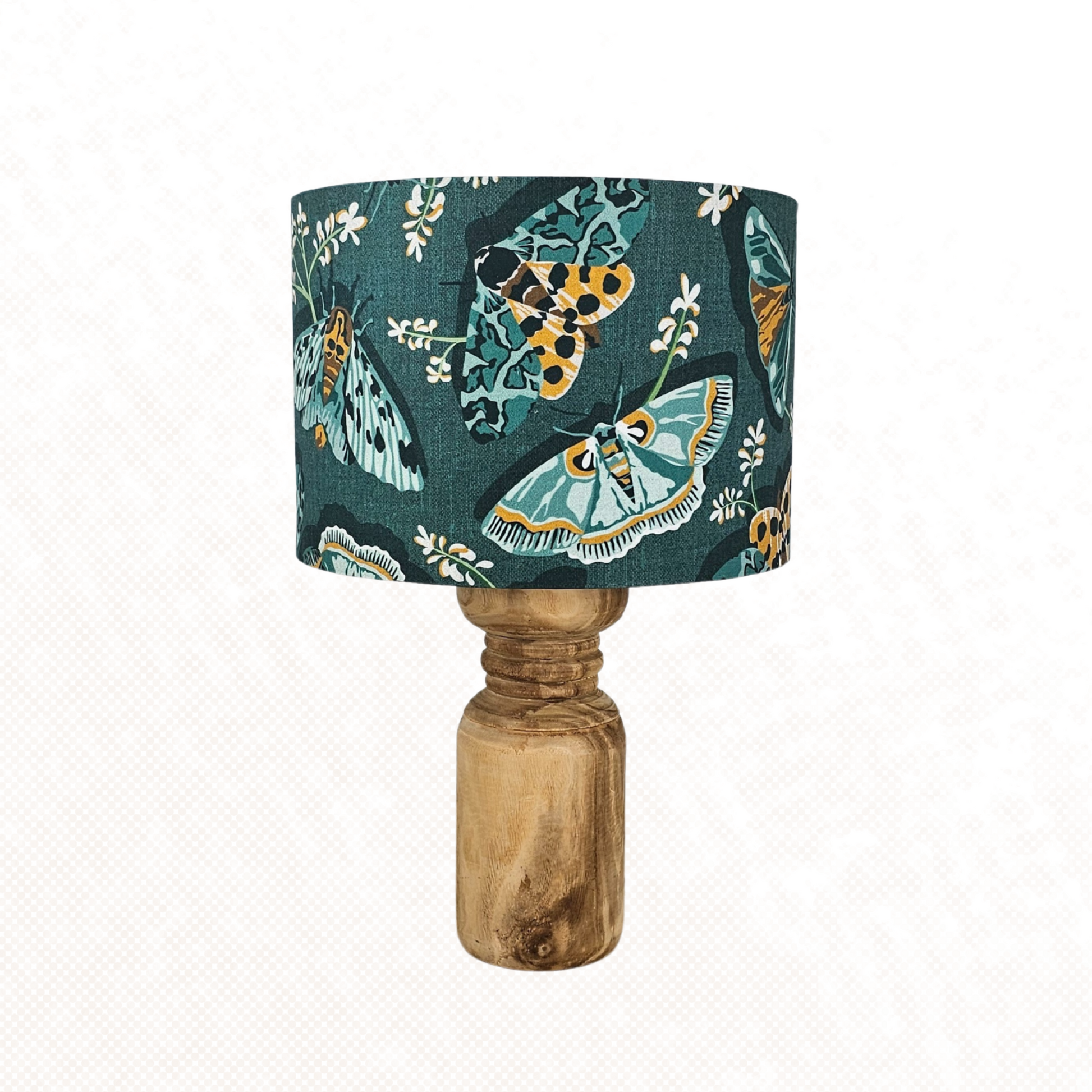 Lampshade with green and yellow moths on an emerald green background against a white background